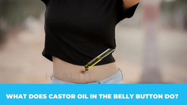 Glass dropper applying castor oil into a human belly button
